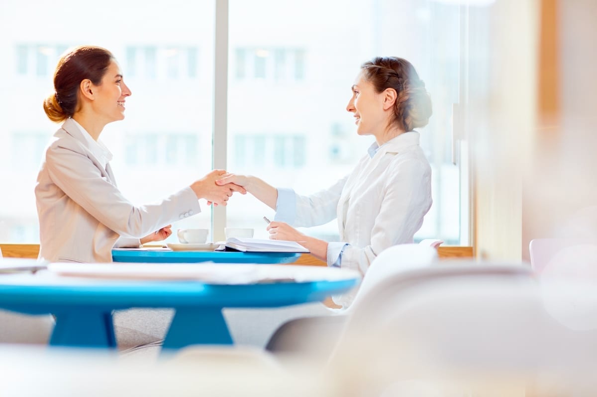 Recruitment, hiring. Two businesswomen shaking hands.