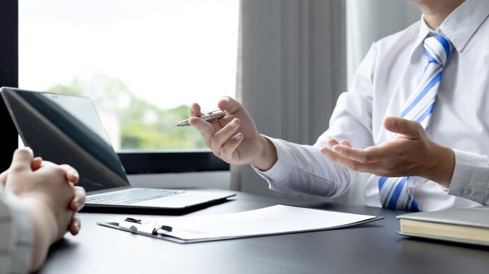 cropped shot of a hiring manager and applicant talking in a job interview